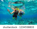 Happy family - mother, kid in snorkeling mask dive underwater with tropical fishes in coral reef sea pool. Show by hands divers sign OK. Travel lifestyle, beach adventure on summer holiday with child.