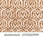 Small photo of Hand made patterns engraved on plaster wall. Moroccan traditional plaster work. Abstract ornamented plaster wall textured background. Islamic patterns on plaster wall.