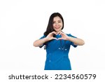 Heart shape hands showing, Medical nurse character woman hospital worker, Young confident Asian woman nurse hospital worker in blue clothing isolated on white background.
