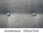 Seamless background texture close up of a grey sofa back with button detail on a thick cloth.
