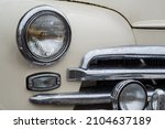 Small photo of NIZHNY NOVGOROD, RUSSIA - JUNE 15, 2020: Classic Soviet Car Exhibition. Headlight of vintage soviet car - white GAZ M20 Volga - close up. Historical, retro, vintage and nostalgia concept