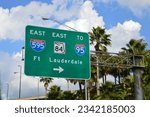 Fort Lauderdale Highway sign with directional arrow directing traffic east to interstate 595, interstate 95 and state road 85. 