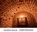 Vaulted wine cellar
 ceiling with red bricks and yellow light