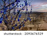Small photo of Nazar, charms to ward off the evil eye , on the branches of a tree in Cappadocia, Turkey