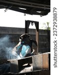 Small photo of A skilled welding expert expertly operates gas welding equipment. Dancing sparks form an intriguing pattern as they flawlessly meld the metal.