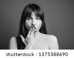 Small photo of Abashed beautiful woman. Shocked facial expression. Black and white closeup portrait of emotional brunette girl.