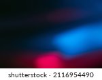 Neon blur glow. Color light overlay. Disco illumination. Defocused blue pink red ultraviolet radiance soft texture on dark black abstract empty space background.