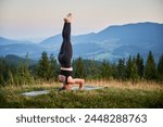 Woman practicing yoga outdoors...