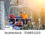 Skier and snowboarder riding up to the top of the mountain on ski lift and showing thumbs up gestures of good class, with an beautiful view nature. Bukovel, Ukraine