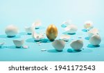 Small photo of Intact golden egg among broken white eggs. The concept of reliability, resistance to adverse conditions.