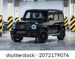 Small photo of St Petersburg, Russia - October 25, 2021: Mercedes-Benz G-Class AMG 63 AMG II W463 G63 front view, three quarters view, headlight on