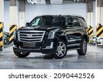 Small photo of St Petersburg, Russia - October 31, 2021: Cadillac Escalade IV front view, three quarters view, headlight on
