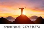 Small photo of Silhouette of a business person on the top of a mountain peak in sunset background. Winner and conquer of businessman concept.