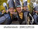 Small photo of New York, NY, USA - November 25, 2021: Two happy marching band members posing at the 95th annual Macy's Thanksgiving Day Parade in NYC