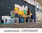 Small photo of A graffiti artist spry paint a wall - 07.09.2023 Amsterdam