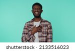 Small photo of Bearded adult african american man laughing out loud after hearing ridiculous anecdote, funny joke, feeling carefree amused, positive people lifestyle. Young guy isolated alone on blue background