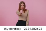Small photo of Angry aggressive greedy businesswoman girl in beige blouse showing fig gesture, you dont get it anyway. Body language. Refusal fig sign. Young adult woman isolated alone on pink studio background