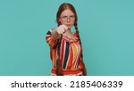 Small photo of Greedy avaricious redhead girl showing fig negative gesture, you dont get it anyway. Rapacious, avaricious, acquisitive. Refusal fig sign. Angry aggressive teenager ginger child kid on blue background