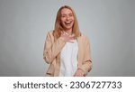 Small photo of Amused office secretary woman looking to camera, laughing out loud, taunting making fun of ridiculous appearance, funny joke anecdote. Business girl isolated alone on gray studio background
