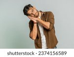 Small photo of Tired exhausted Indian young man yawning, sleepy inattentive feeling somnolent lazy bored gaping suffering from lack of sleep, falling asleep. Arabian Hindu guy isolated on gray studio background