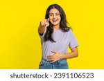 Small photo of Happy Indian young woman laughing out loud after hearing ridiculous anecdote, reaction on funny joke, feeling carefree amused. Positive people lifestyle. Arabian girl isolated on yellow background