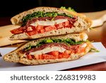 Small photo of Sandwiches. Italian Panini. Roast Beef or Cuban Sandwich. American Diner sandwich. Sliced roast beef topped with melted Swiss cheese on top of a toasted hero roll with lettuce tomato and onion.