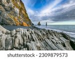 Small photo of Gorgeous landscape with basalt rock formations Troll Toes on Black beach Reynisfjara near the village of Vik. Location: Reynisfjara Beach, Vik Village, Iceland (Sudurland), Europe