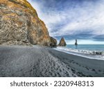 Small photo of Breathtaking view of rock formations Troll Toes on Black beach Reynisfjara near the village of Vik. Location: Reynisfjara Beach, Vik Village, Iceland (Sudurland), Europe