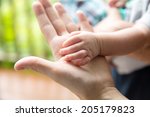 Royalty free image of a baby's hand on top of mother's hand. Shallow depth of field.