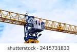 Small photo of The cabin of construction tower crane, crane.Turret Slewing Crane against blue sky