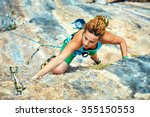 Female Rock Climber Climbs On A ...