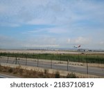 Small photo of BARCELONA, SPAIN - 23th of July 2022: Iberia airplane landing in Barcelona- El Prat Airport. Iberia is a spanish airline. Views from "El Delta del Llobregat"