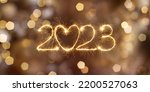 Small photo of Happy New Year 2023. Beautiful holiday billboard with Sparkling creative text 2023 with heart on festive glowing golden background