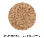 Top view texture of handmade round beige wicker tablecloth surface isolated on white background. Household utensils. Rustic decoration