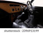 Small photo of Somerset, England - 08252017: Interior view of classic Triumph Spitfire 1500 car dashboard, gear stick and steering wheel