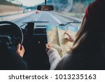 Happy couple traveling by authentic car in Europe, hipster girl holding touristic map planning route in mountains, lifestyle roadtrip travel concept