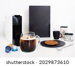 The coffee machine makes americano black coffee from coffee capsule. Set prop with snack and capsule package box.