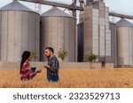 Small photo of A knowledgeable Chinese agronomist and silo owner meet in a wheat field to assess its readiness for harvest. Engaged in discussion, they compare data and observations, ensuring a thorough evaluation.