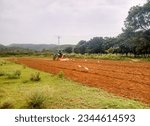 Small photo of Sawai Madhopur, India - August 9, 2023: Field cultivation by rotatory tiller cultivator, Indian agriculture, field cultivation by tractor
