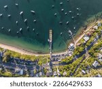 Small photo of High angle aerial evening bird's eye view of Palm Beach coastline and the ferry Wharf . Palm Beach is an affluent beachside suburb in the Northern Beaches region of Sydney, New South Wales, Australia.
