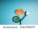 Health Care, Harmony and Organic Healthy Lifestyle Concept. Living and Close to Nature. Wooden Jigsaw as Heart Shape with Stethoscope and Leaf. Look like Flower Plant. Growth of Love and Relationship