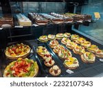 Small photo of Shop shelves. Cakes and goodies. Cake stand. Fruit and cream. Assortment in the supermarket. Unhealthy food. Products with sugar. Sweets