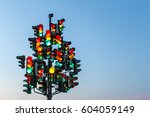 Traffic light tree with a lot of lamps under sky with a sunset.