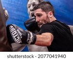 Small photo of HELSINKI, FINLAND – NOVEMBER 11 2021: Professional boxer Jose Antonio Sanchez Romero punching the heavy bag at Ringside Gym