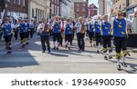 Small photo of Chichester, Sussex, UK - 20 Apr 2019: Martlet Sword and Morris dancers, in blue and yellow tunics, perform a traditional folk dance in a shopping street. Musicians lead the troupe with accordions.