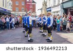Small photo of Chichester, Sussex, UK - 20 Apr 2019: Martlet Sword and Morris men perform a traditional English folk dance entertaining shoppers. Dancers have blue tunics with yellow birds and ribbons and sticks.
