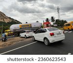 Small photo of "Sulur, Tamilnadu India - June 27 2022: A view of vehicles swerving to a side road on the National Highway".
