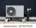 Small photo of Heat pump in front og black building