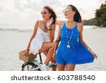 young beautiful hipster girls having fun on beach, traveling in asia, summer vacation,  trendy style, smiling, positive emotion, sunglasses, happy, beach, bicycle, blue and white dress, tanned skin