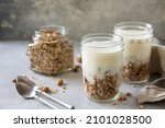 Healthy breakfast, yogurt parfait. Yogurt with homemade almond granola on a gray concrete background. Copy space.